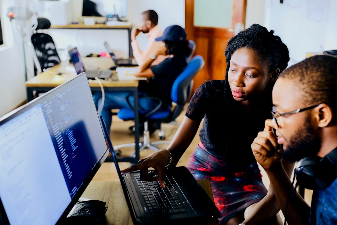 Pessoas utilizando computadores em atividade colaborativa